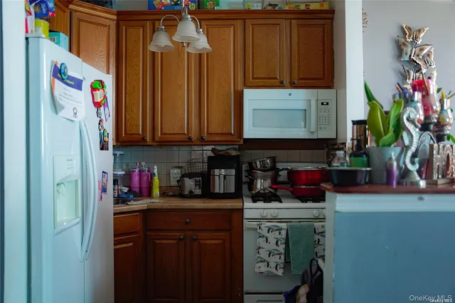 a kitchen with a refrigerator and cabinets