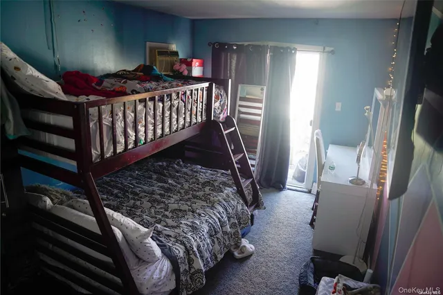 a bedroom with furniture and a window