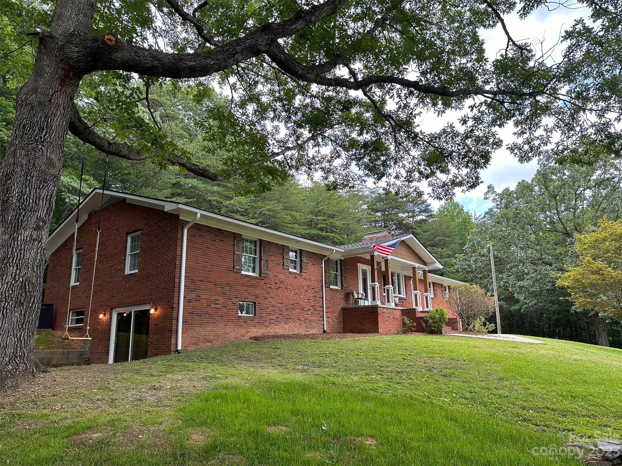 49 Community Road Fletcher, NC 28732 - Photo 3 of 38 a house view with a garden space