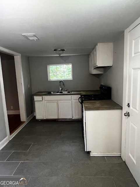 2033 3rd Avenue Macon, GA 31204 - Photo 11 of 12 a kitchen with stainless steel appliances a sink stove and cabinets