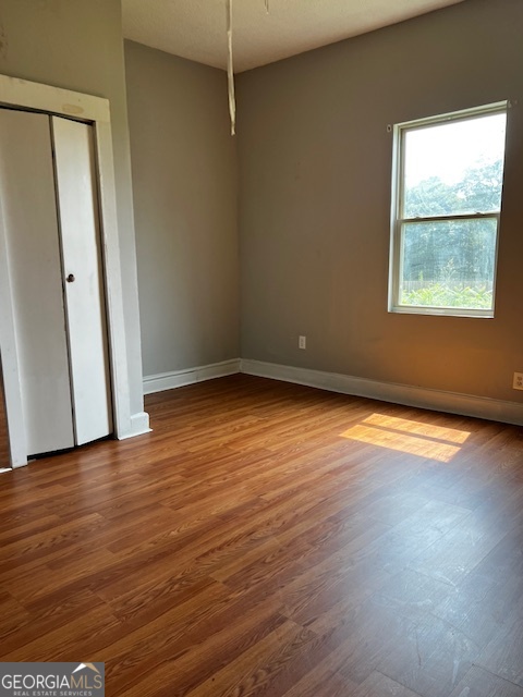 2033 3rd Avenue Macon, GA 31204 - Photo 7 of 12 an empty room with wooden floor and windows
