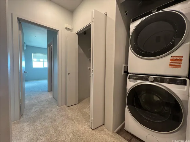 a view of a hallway with washer and dryer