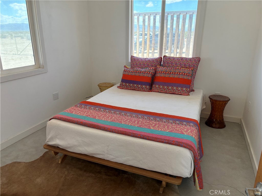 86515 Amboy Road Twentynine Palms, CA 92277 - Photo 11 of 34 a bed sitting in a bedroom next to a window