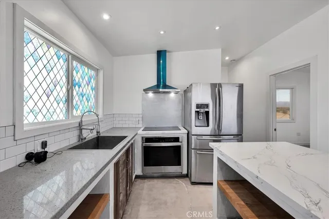 a kitchen with a sink stove and refrigerator