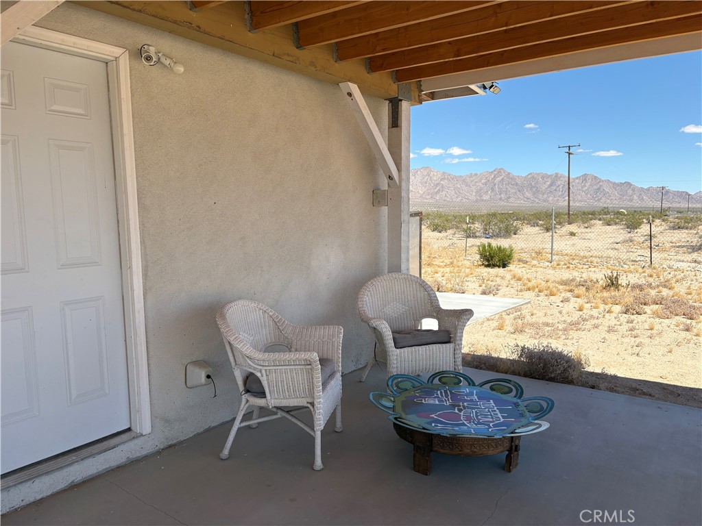 86515 Amboy Road Twentynine Palms, CA 92277 - Photo 17 of 34 a living room with furniture and a floor to ceiling window