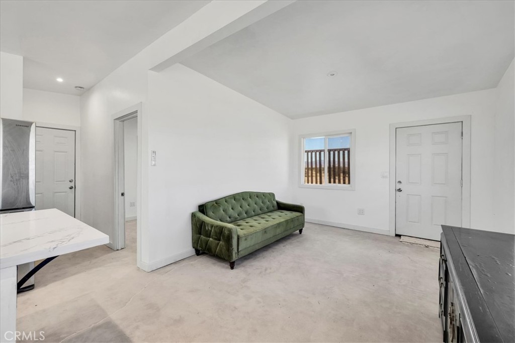 86515 Amboy Road Twentynine Palms, CA 92277 - Photo 7 of 35 a living room with a bed and a couch