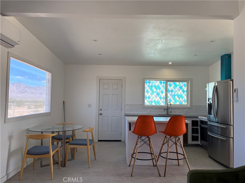 86515 Amboy Road Twentynine Palms, CA 92277 - Photo 9 of 34 a view of a dining room with furniture window and outside view