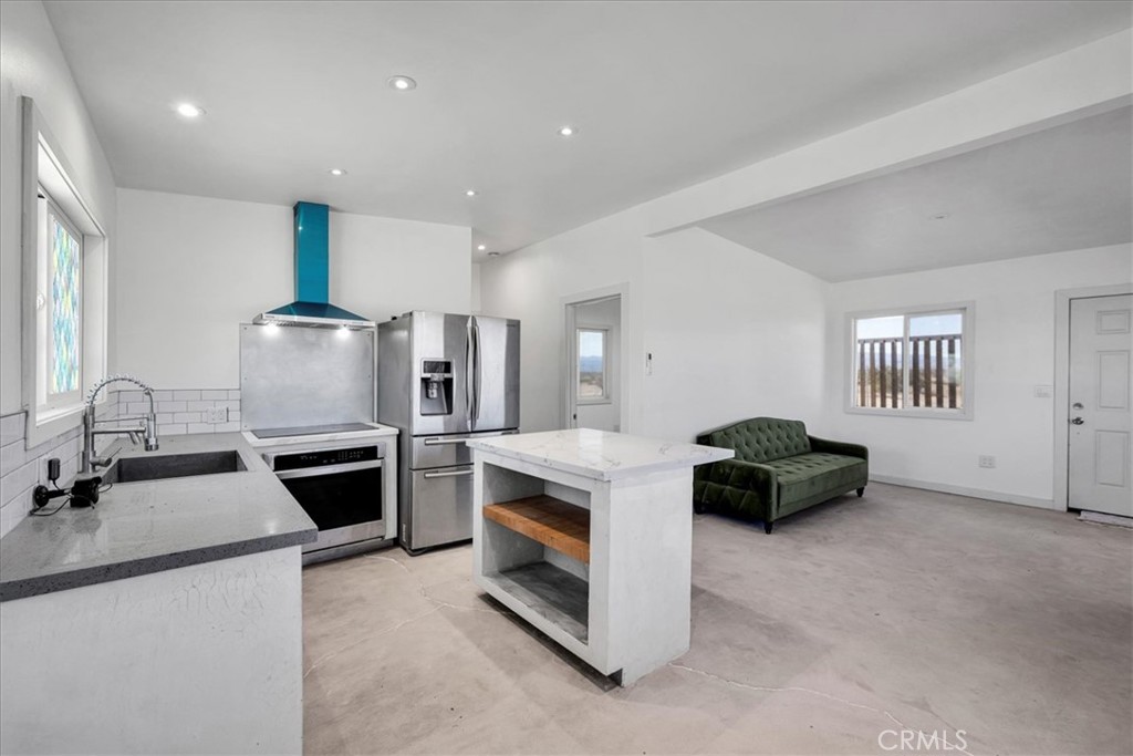 86515 Amboy Road Twentynine Palms, CA 92277 - Photo 10 of 35 a kitchen with stainless steel appliances granite countertop a sink stove and refrigerator