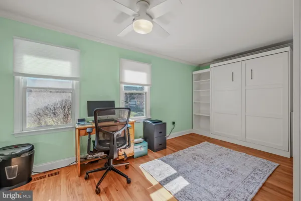 a workspace with furniture and wooden floor