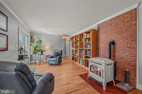 a living room with furniture a rug and a bookshelf