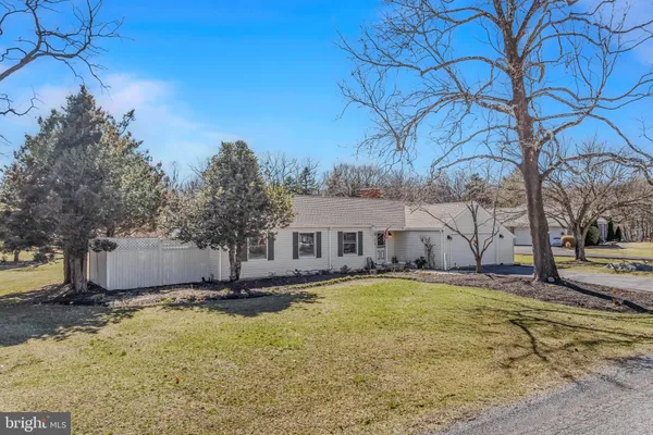 a view of a house with a yard covered with snow