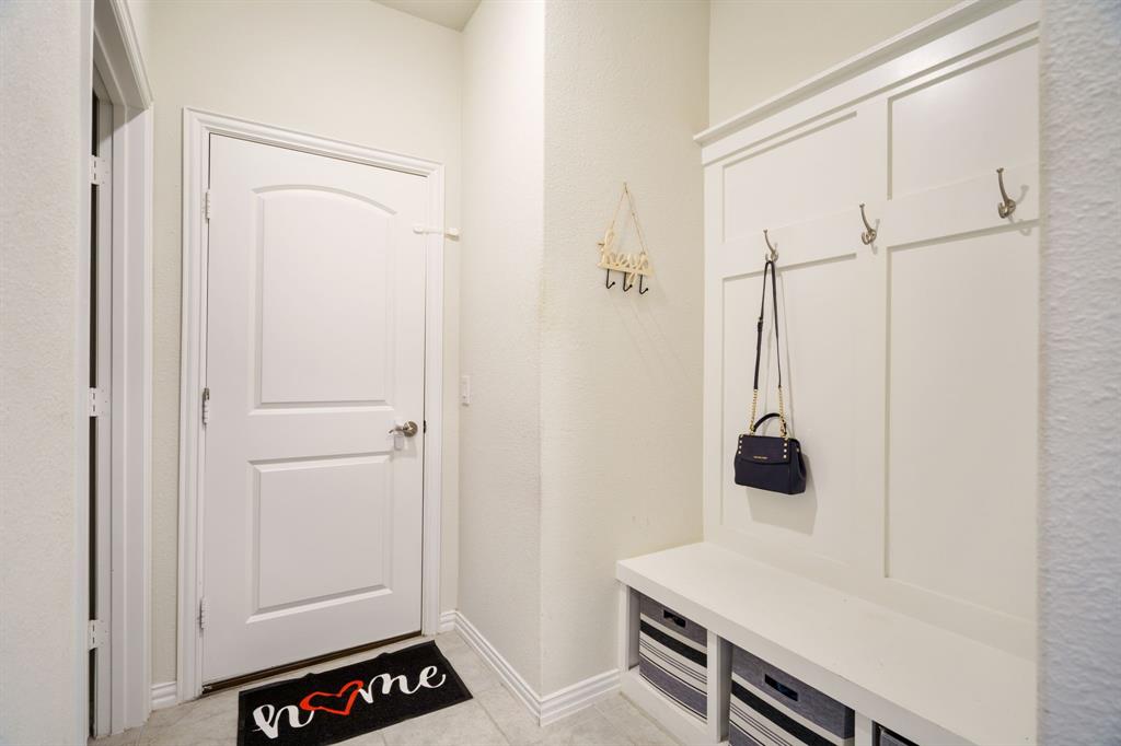 6049 Iron Creek Road Fort Worth, TX 76137 - Photo 15 of 30 a room with a table and white appliances