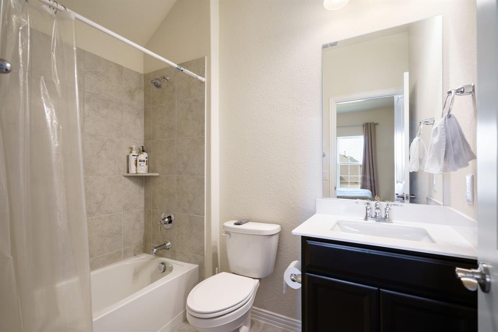 6049 Iron Creek Road Fort Worth, TX 76137 - Photo 21 of 30 a bathroom with a sink toilet a mirror and shower