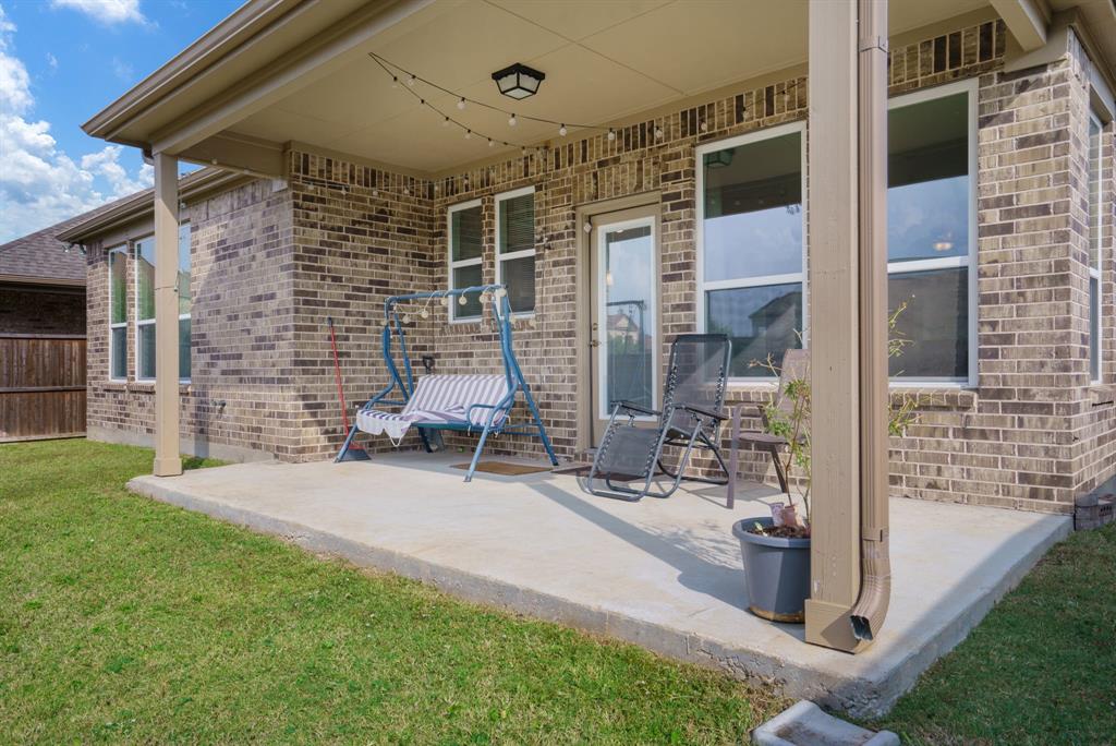6049 Iron Creek Road Fort Worth, TX 76137 - Photo 23 of 30 a view of a patio with table and chairs and potted plants