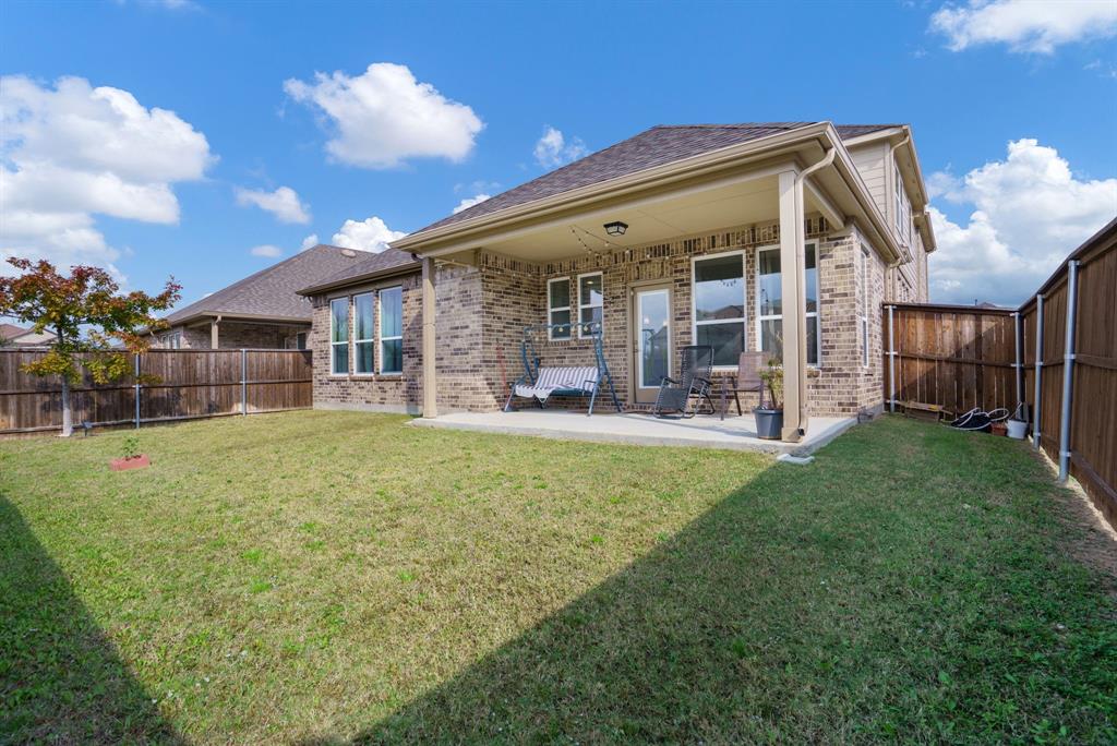 6049 Iron Creek Road Fort Worth, TX 76137 - Photo 24 of 30 a view of a house with a backyard porch and sitting area