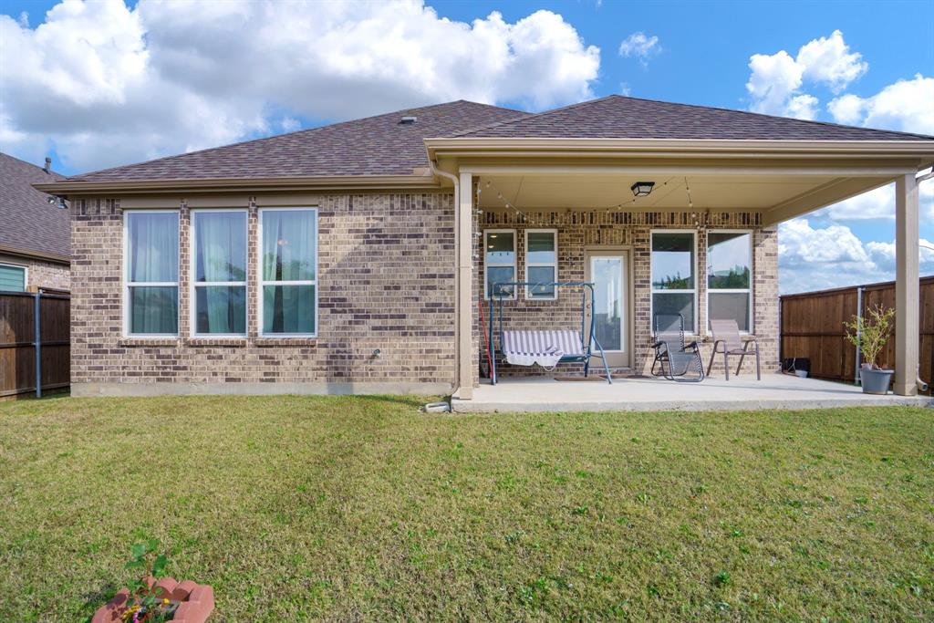 6049 Iron Creek Road Fort Worth, TX 76137 - Photo 25 of 30 a view of a house with a yard and front door