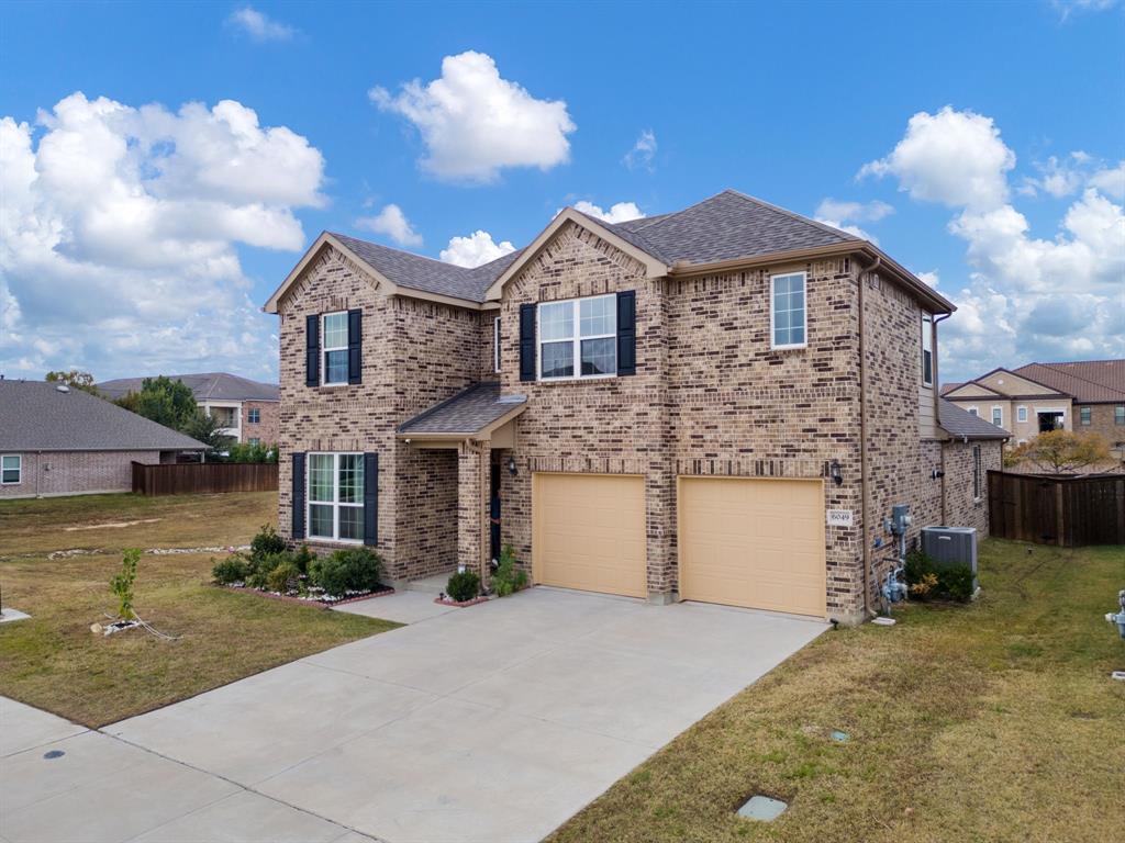 6049 Iron Creek Road Fort Worth, TX 76137 - Photo 3 of 30 a front view of a house with a yard and garage