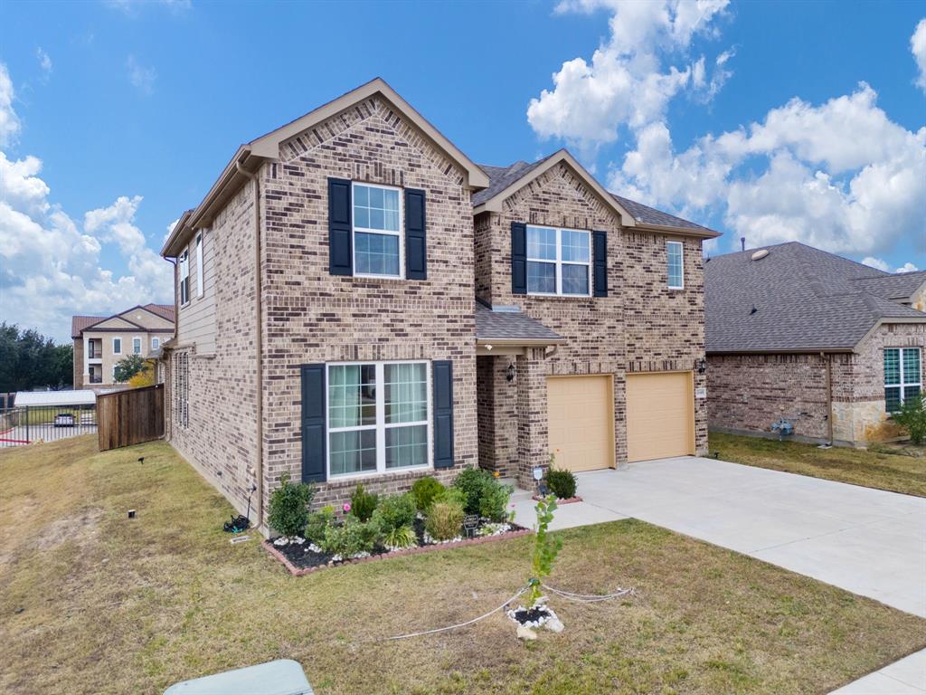 6049 Iron Creek Road Fort Worth, TX 76137 - Photo 4 of 30 a front view of a house with a yard and garage