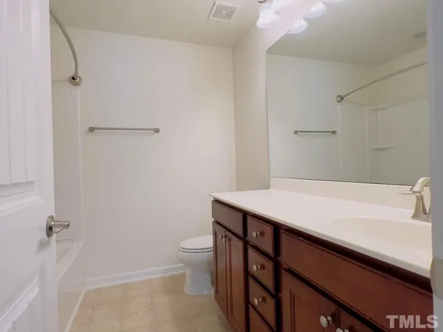 a bathroom with a sink a toilet and a shower