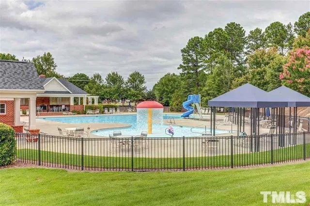 a view of a patio with couches and table and chairs with wooden floor and fence