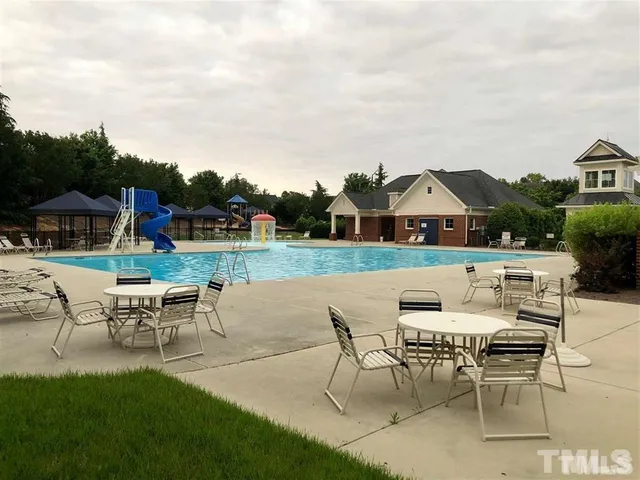 a patio with a table and chairs under an umbrella