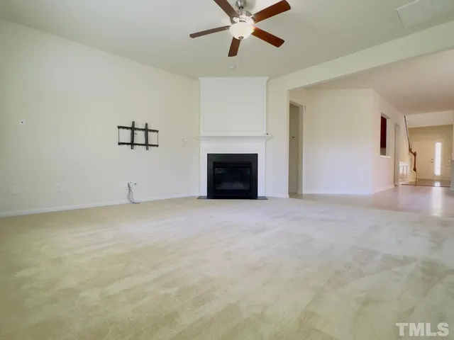 a view of a livingroom with a ceiling fan and window