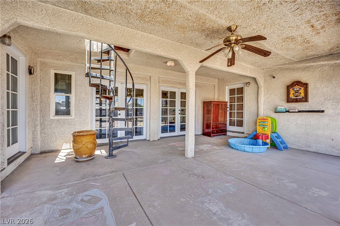420 North Racetrack Road Henderson, NV 89015 - Photo 38 of 52 A spacious covered patio offers a spiral staircase and multiple French doors, perfect for outdoor enjoyment.