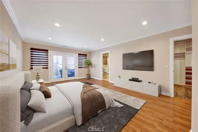 a bedroom with a bed and a flat screen television