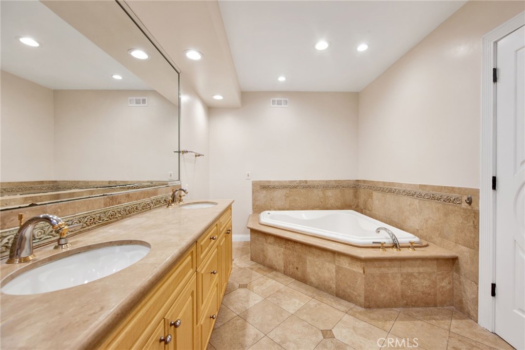 1259 Swarthmore Drive Glendale, CA 91206 - Photo 17 of 33 a bathroom with a granite countertop sink a toilet and a tub