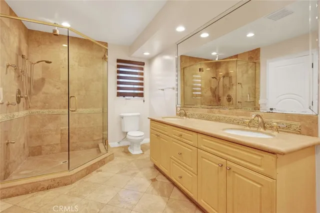a spacious bathroom with a granite countertop sink mirror and shower