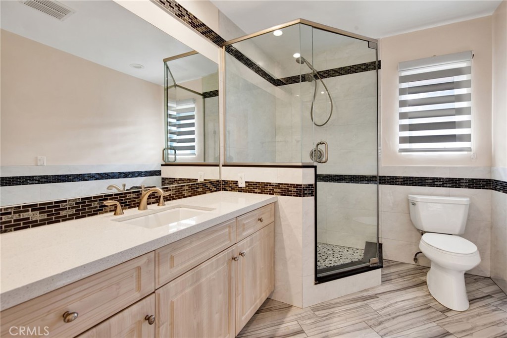 1259 Swarthmore Drive Glendale, CA 91206 - Photo 22 of 33 a bathroom with a sink a toilet and a mirror
