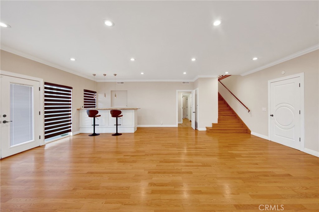 1259 Swarthmore Drive Glendale, CA 91206 - Photo 24 of 33 a view of an empty room with wooden floor and stairs