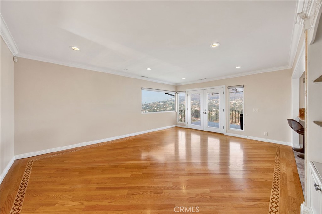 1259 Swarthmore Drive Glendale, CA 91206 - Photo 10 of 33 a view of an empty room with wooden floor and a window