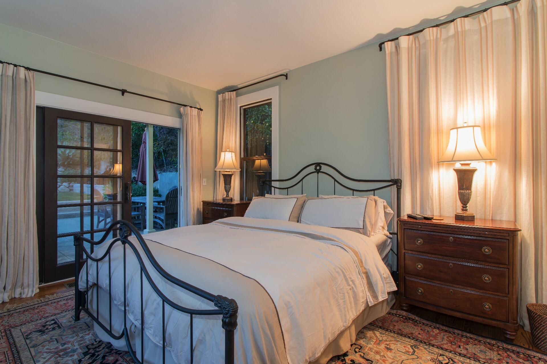 Undisclosed Address Santa Barbara, CA 93101 - Photo 11 of 24 a bedroom with a bed a mirror and a window