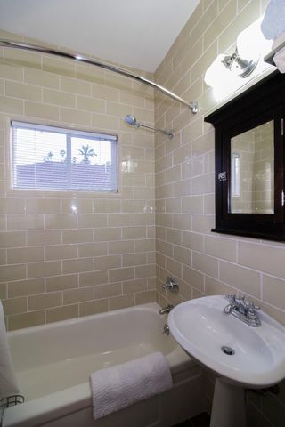 a bathroom with a sink shower and a bathtub