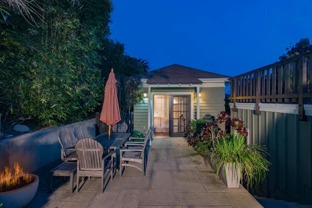 a view of a house with backyard and sitting area