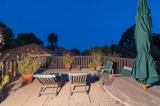 a view of a chairs and table in patio