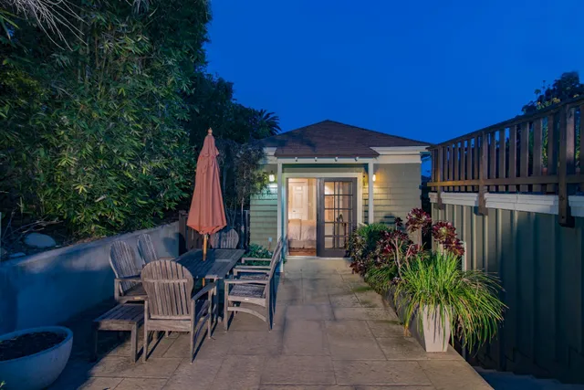 a view of a house with backyard and sitting area