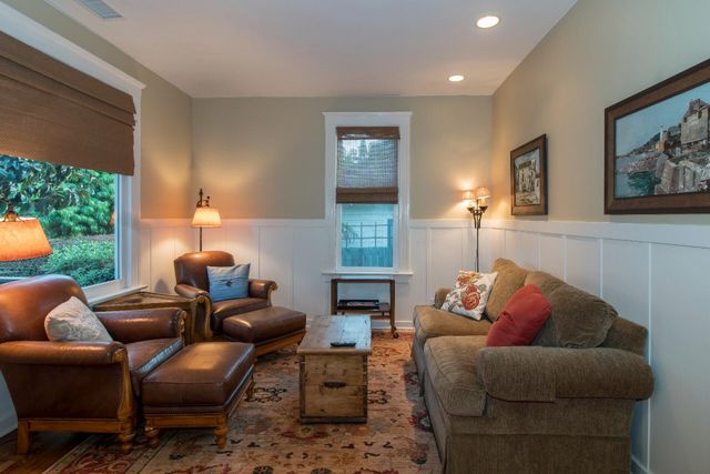 a living room with furniture fireplace and window