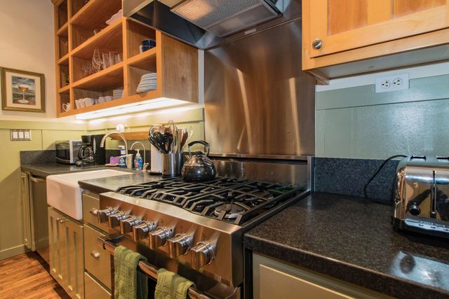 a stove top oven sitting inside of a kitchen