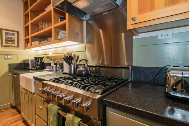 a stove top oven sitting inside of a kitchen