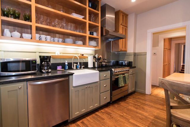 a kitchen with a stove top oven and cabinets