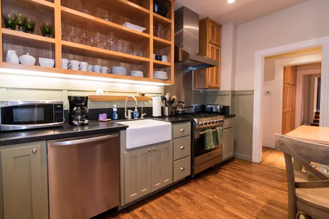a kitchen with a stove top oven and cabinets