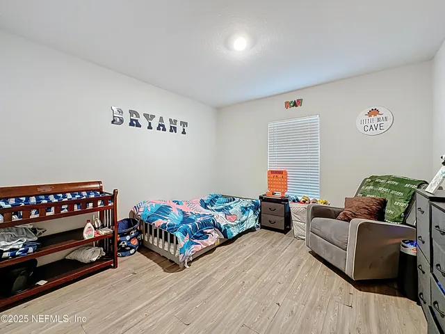 a bedroom with furniture and a wooden floor