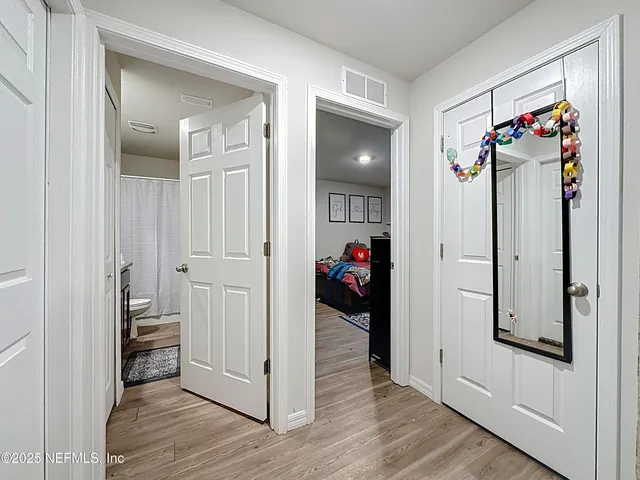a view of a hallway with closet and a livingroom view