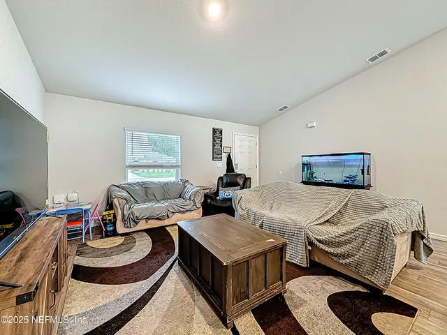 a bedroom with furniture and a window