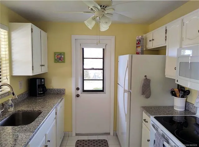 a living room with furniture and a flat screen tv with wooden floor