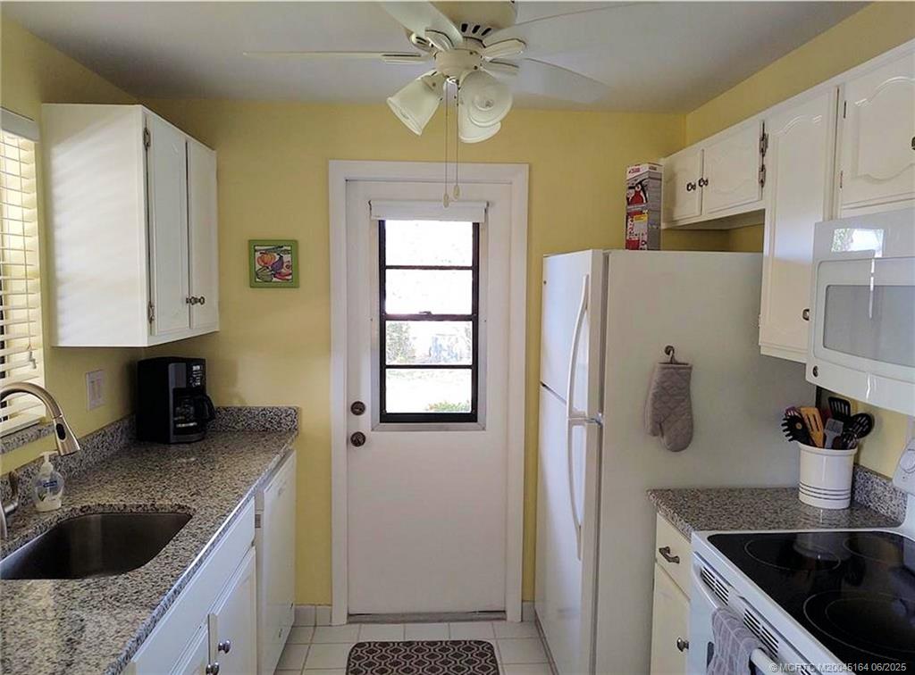 Undisclosed Address Stuart, FL 34997 - Photo 11 of 81 a kitchen with stainless steel appliances granite countertop a sink stove and refrigerator