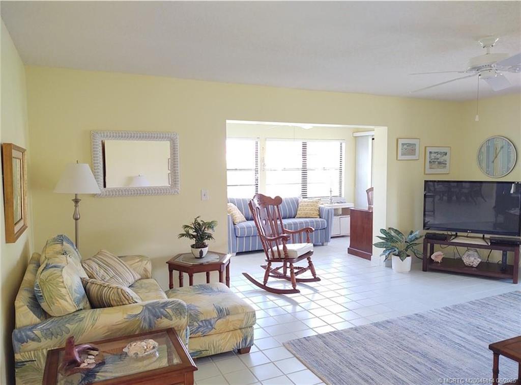 Undisclosed Address Stuart, FL 34997 - Photo 15 of 81 a living room with furniture and a flat screen tv with wooden floor