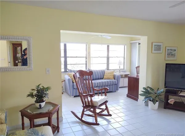 a bedroom with a large bed and a flat tv screen on dresser